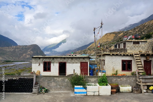 Typical Nepalese houses made of blocks with flowers in front of them in the city of Jomsom in Nepal, Mustang district.