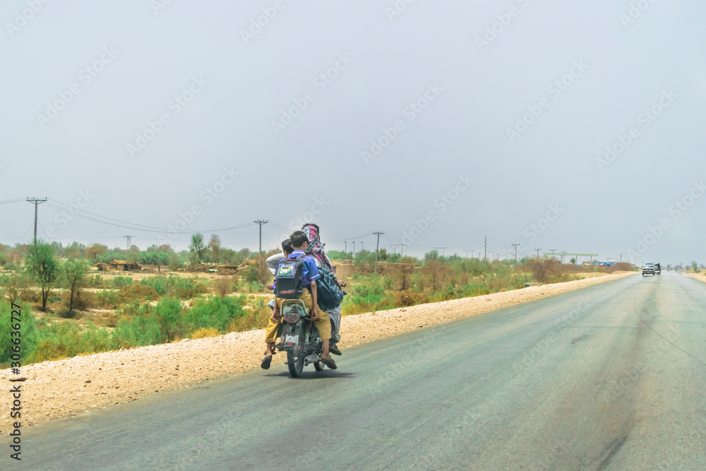 a father is taking his children to school on a speedy highway at high risk of accident cause of transportation crises a father is taking his children to school on a speedy highway at high risk of accident cause of transportation crises