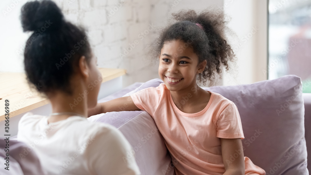 Smiling little girl talk sharing secret with mum Smiling little girl talk sharing secret with mum