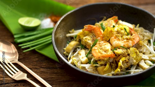Thai traditional food: Still life of Pad Thai, stired noodles with shrimps, egg served with lime,vegetable. Pad Thai is popular on street food, Thailand, Clean food good taste concept.