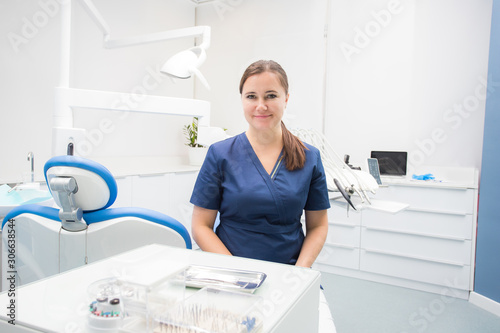 female dentist sitting in a treatment room