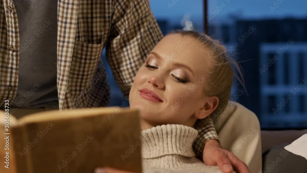 New Year. Young Couple Reading Book In Bed. New Year. Young Couple Reading Book In Bed.