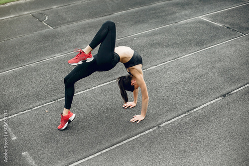 Beautiful girl at the stadium. Sports girl in a sportswear.