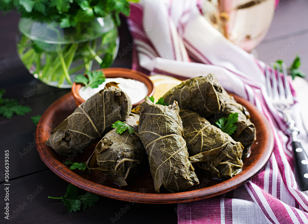 Dolma. Stuffed grape leaves with rice and meat on dark table. Middle eastern cuisine. Dolma. Stuffed grape leaves with rice and meat on dark table. Middle eastern cuisine.