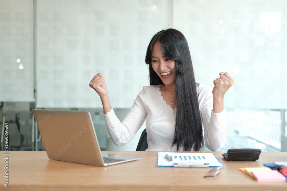businesswoman feeling happy glad showing yes gesture at office. freelance woman using computer. business concept businesswoman feeling happy glad showing yes gesture at office. freelance woman using computer. business concept