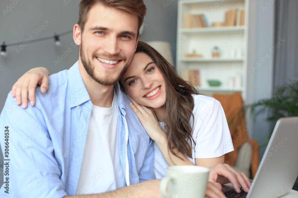 Couple pointing while working together on laptop. Couple pointing while working together on laptop.