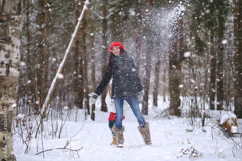 A winter fairy tale,in the forest. A girl on a sled with gifts on the eve of the new year in the park. Two sisters walk in a New Year's park and ride a sled with gifts.