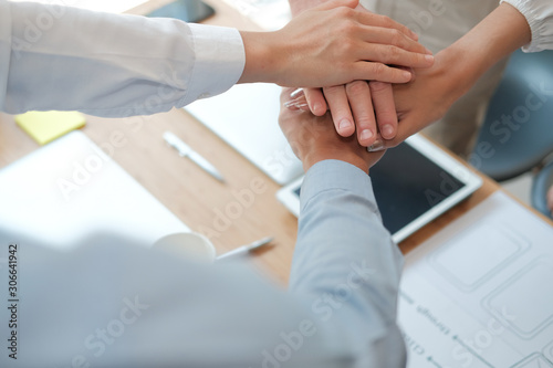 businessman businesswoman joining united hand, business team touching hands together. unity teamwork partnership concept. © 88studio