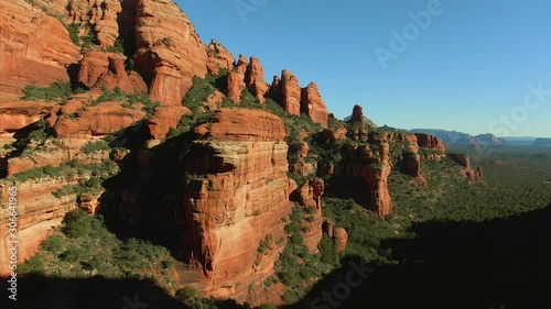 Aerial rising from the orange and green canyons of Red Rock State Park in Sedona Arizona