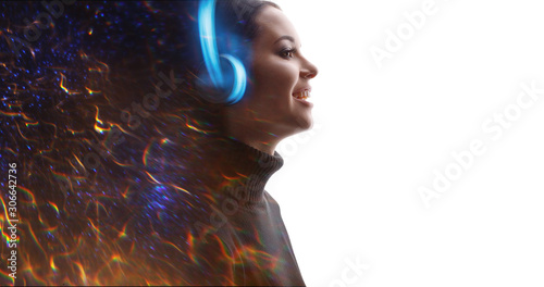 Portrait of smiling woman in headphones listening music. Double exposure of female face, flashes of fire isolated on white background. Digital art. Blue neon light. Free space for text.