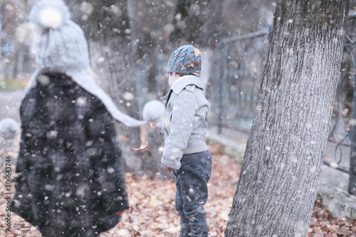 Kids walk in the park first snow