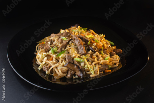 noodles with beef and shiitake mushrooms on the plate