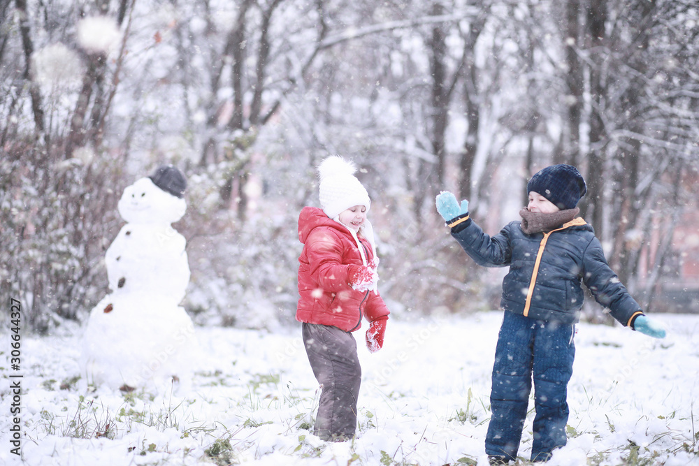 Kids walk in the park first snow Kids walk in the park first snow