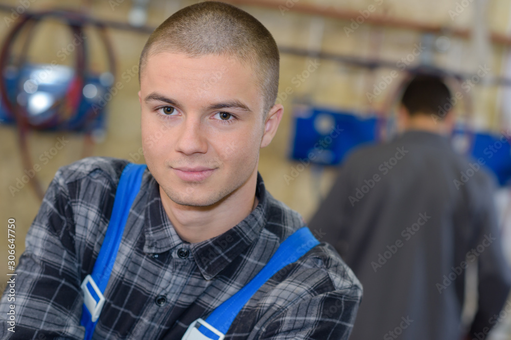 handsome young man working in a factory handsome young man working in a factory