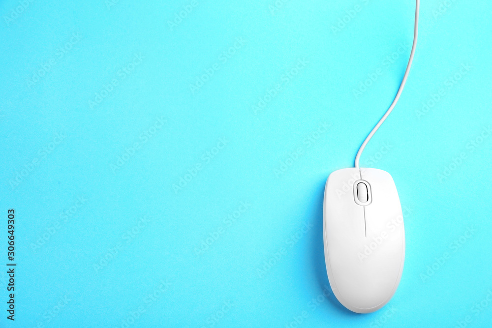 Modern wired mouse on light blue background, top view. Space for text Modern wired mouse on light blue background, top view. Space for text