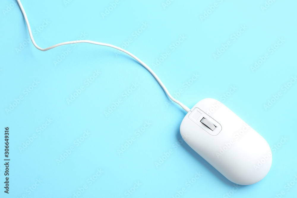 Modern wired mouse on light blue background, top view Modern wired mouse on light blue background, top view