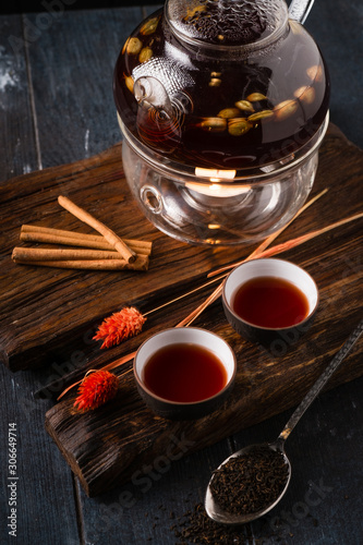 Chinese hot black tea in ceramic cups and teapot. Traditional tea ceremony in the East.