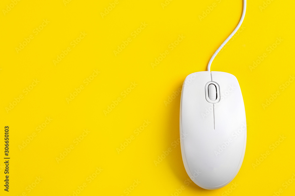 Modern wired optical mouse on yellow background, top view. Space for text Modern wired optical mouse on yellow background, top view. Space for text