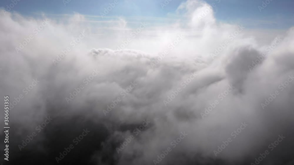 Flying between thick puffy clouds. Aerial cloudscape. Background Flying between thick puffy clouds. Aerial cloudscape. Background