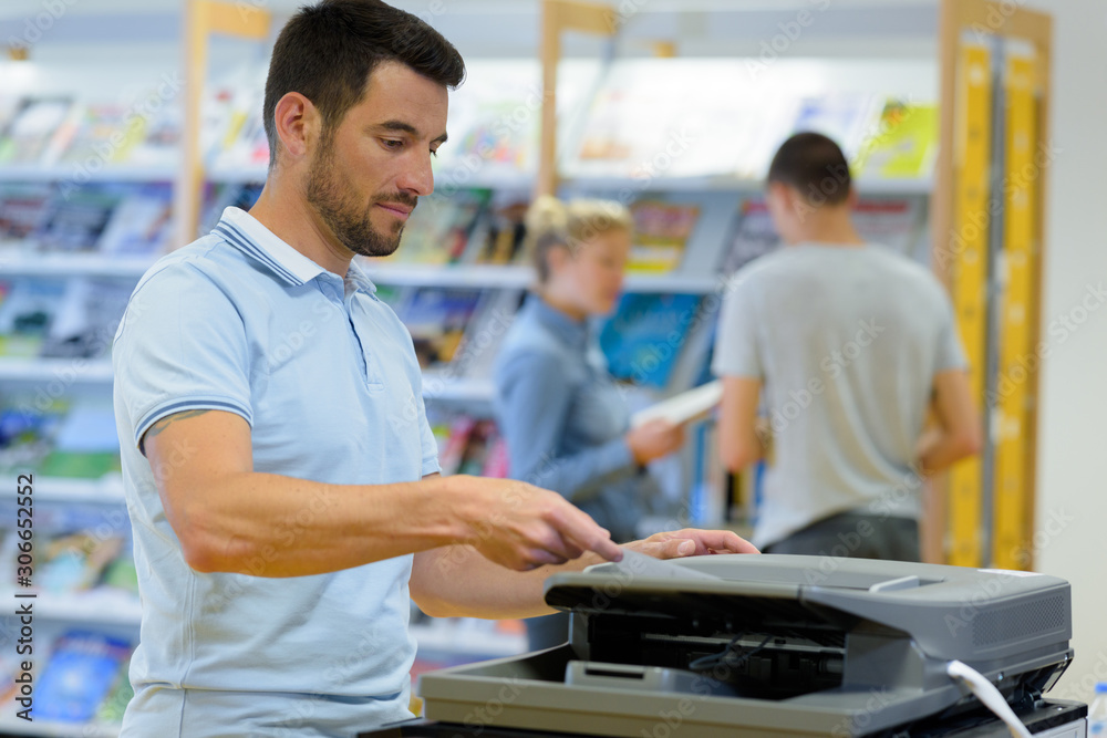 a man using copier machine a man using copier machine