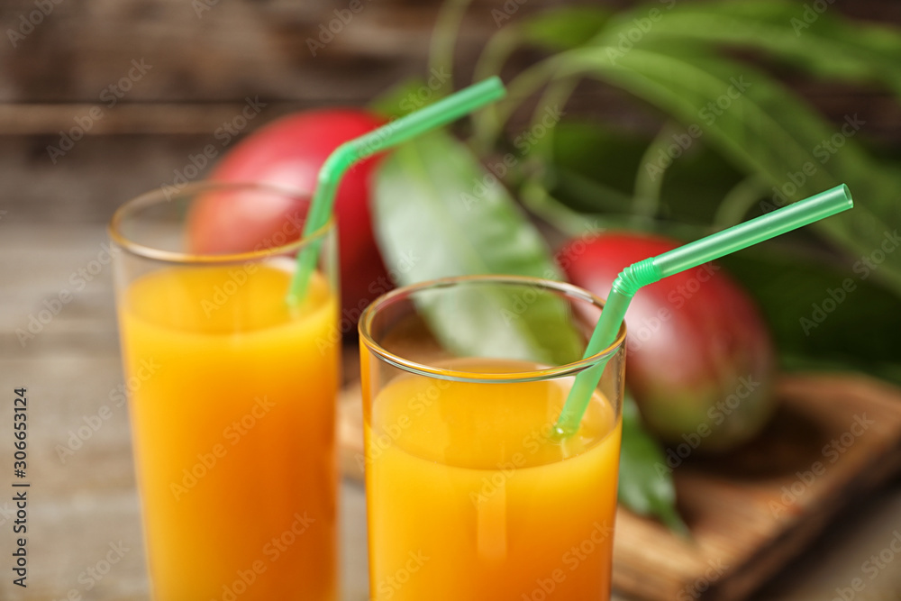 Fresh delicious mango drink on table, closeup Fresh delicious mango drink on table, closeup