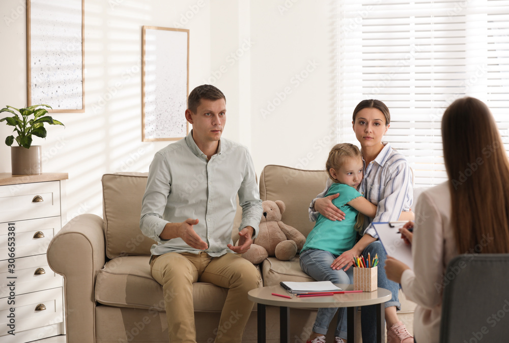 Family on appointment with child psychotherapist indoors Family on appointment with child psychotherapist indoors
