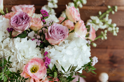 Spring bouquet of mixed flowers on vintage wooden wall background behind