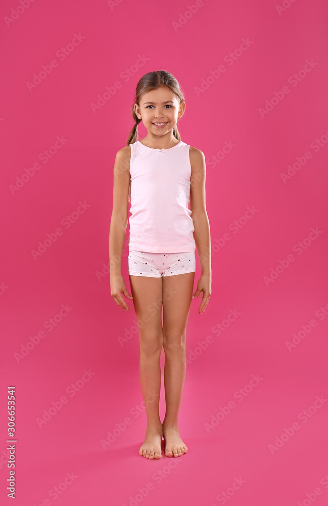 Foto de Cute little girl in underwear on pink background do Stock