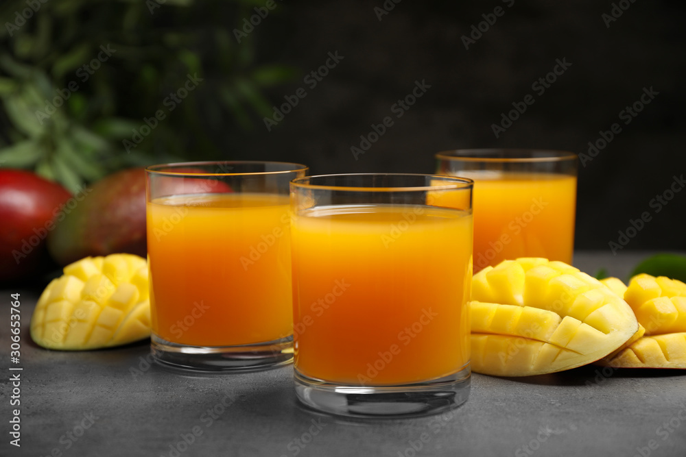Fresh delicious mango drink on grey table Fresh delicious mango drink on grey table