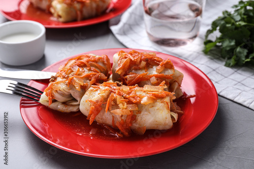Delicious cabbage rolls served on grey table