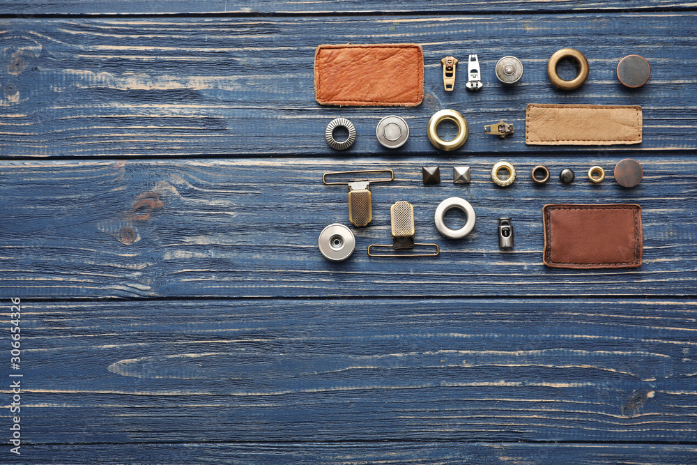 Flat lay composition with garment accessories for jeans on blue wooden background. Space for text Flat lay composition with garment accessories for jeans on blue wooden background. Space for text