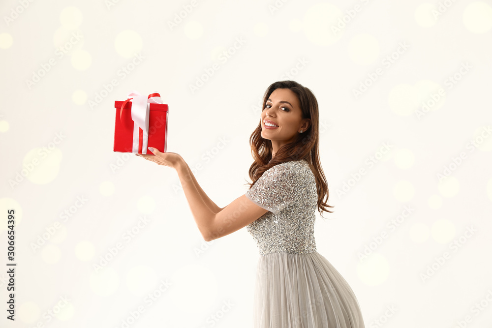 Beautiful woman with Christmas gift on white background Beautiful woman with Christmas gift on white background