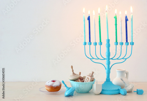 religion image of jewish holiday Hanukkah background with menorah (traditional candelabra), spinning top and doughnut