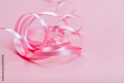beautiful pink ribbon on bright background copy space