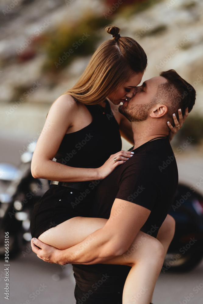 Couple of lovers kissing and hugging on motorbike - Two bikers stop in the countryside