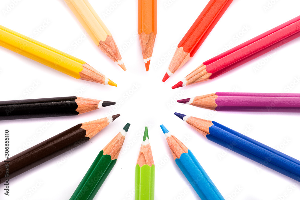 High angle view of colored circle shaped pencils in a row over white background High angle view of colored circle shaped pencils in a row over white background