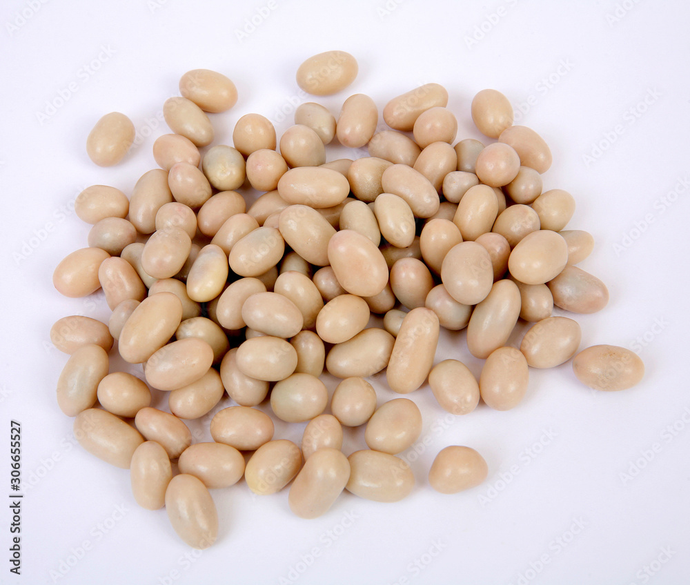 Slice of peanuts in white sugar glaze on a gray structural background