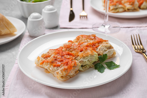 Delicious cabbage rolls served on grey table