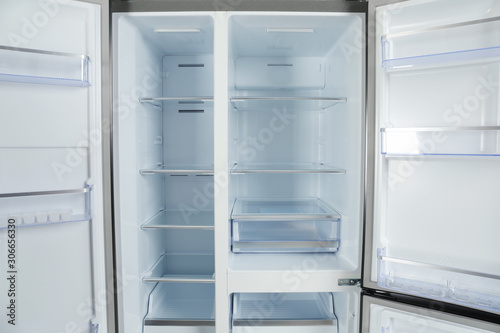 Shelves of empty modern refrigerator, closeup view