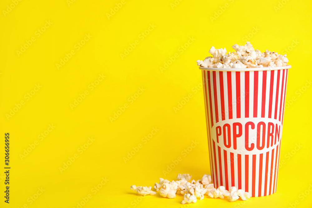 Tasty pop corn on yellow background, space for text