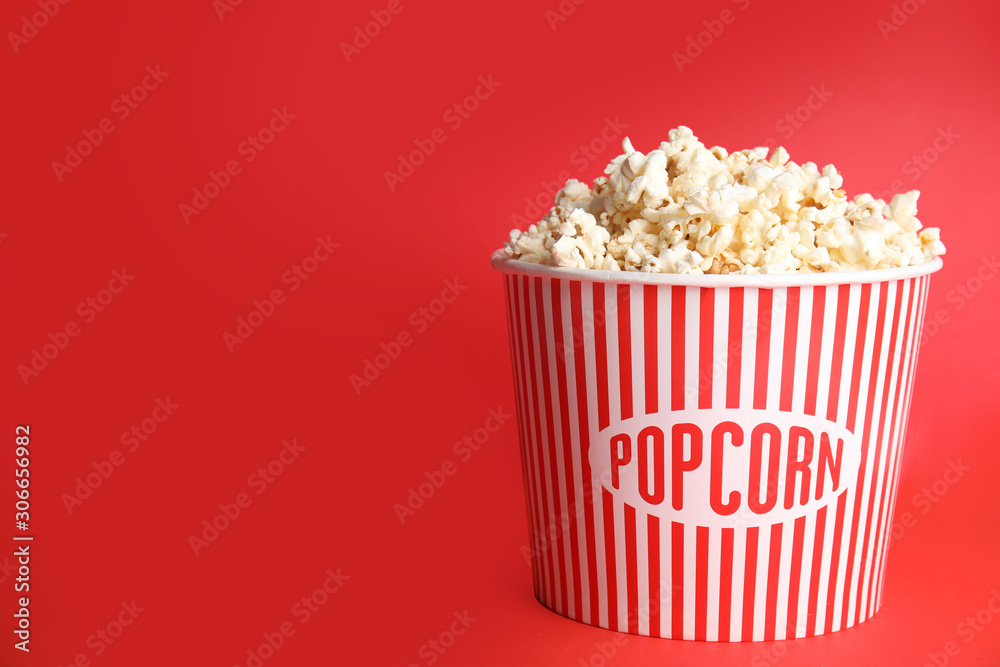 Tasty pop corn on red background. Space for text