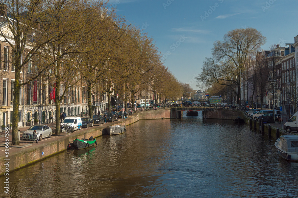 A shot of the canal in Amsterdam, Netherlands, from a bridge in the city in the Winter.