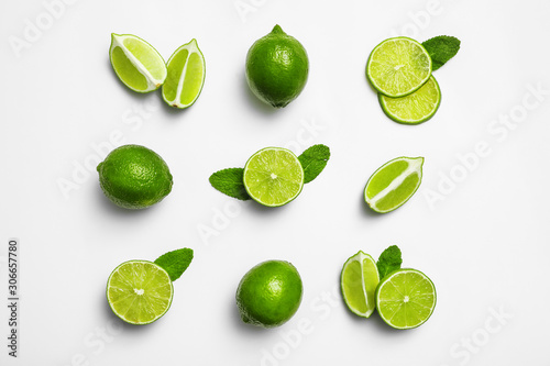 Flat lay composition with fresh juicy limes and mint on white background