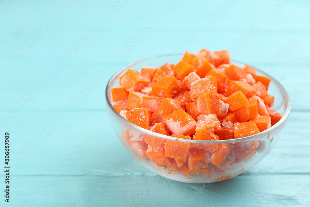 Frozen carrots on light blue wooden table, closeup. Vegetable preservation Frozen carrots on light blue wooden table, closeup. Vegetable preservation