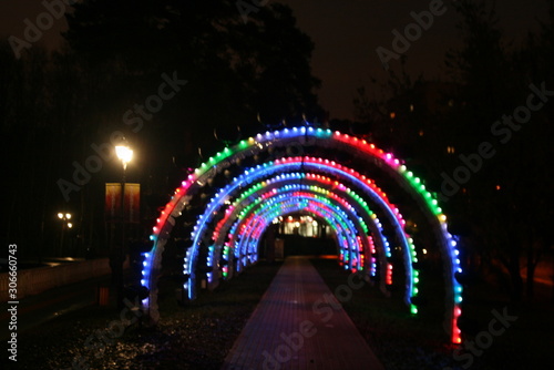 arch with colorful glowing lights at night