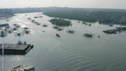 The sunlight reflected in the rippling water caused by boats going across the water in Port Laskar, Belitung Island, Indonesia  photo