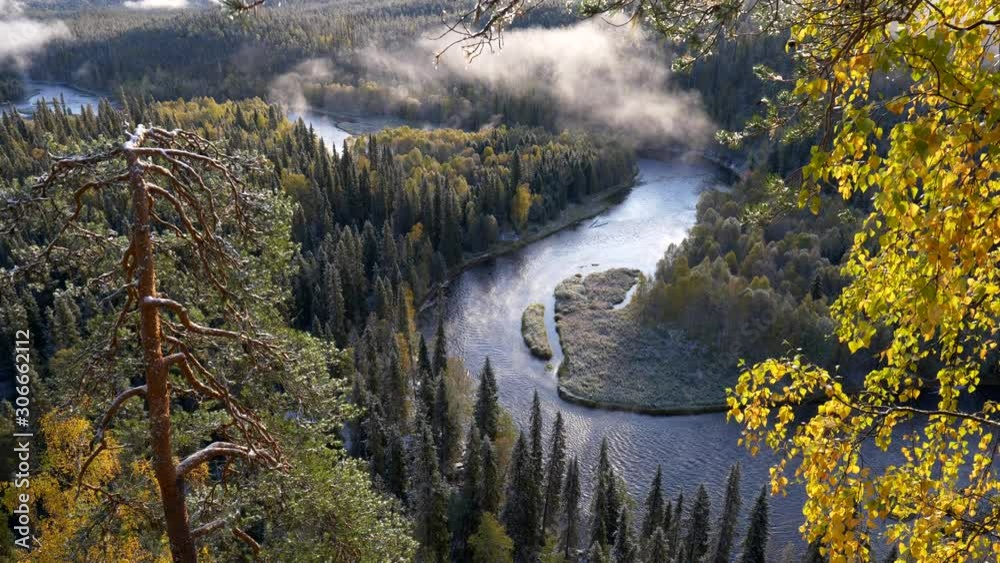 Oulanka National Park, Finland. River and evergreen forest with clouds during sunrise in autumn. UHD