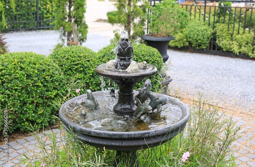 Beautiful Fountain in the park garden. Water flows from the fountain.