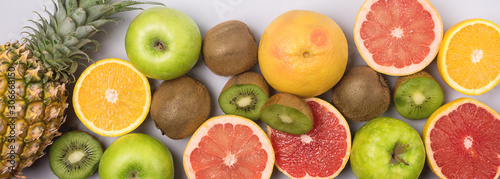 Tropical Fruits on Blue Background Ripe Pineapple Kiwi Oranges Grapefruits Geen Apples Healthy Food Vitamin Diet or Detox Concept Flat Lay Top View Long