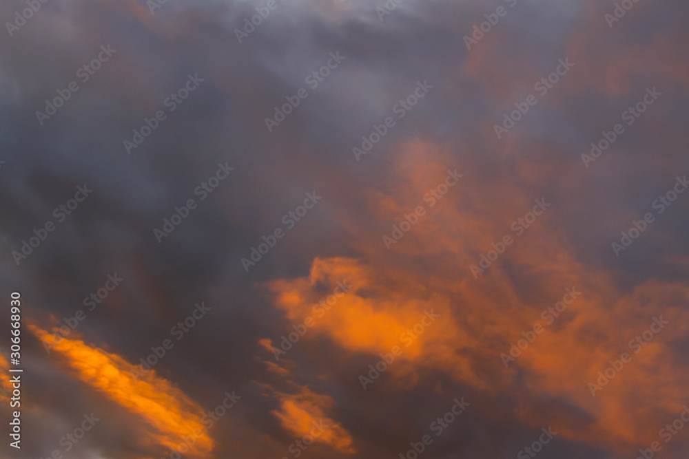 Orange and dark grey clouds close up